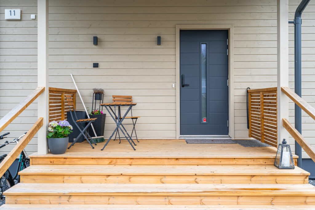 talon sisäänkäynti, portaat kuistille ja pöytäryhmä kuistilla